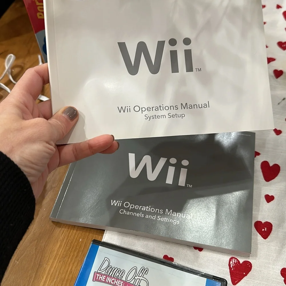 Nintendo Wii black w 2 remotes and 7 games.6 games in cases 1 has no case.